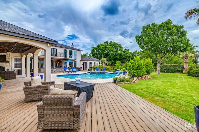 view of pool with a lawn, ceiling fan, an outdoor hangout area, and pool water feature