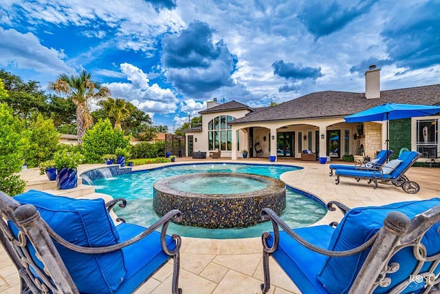 view of swimming pool featuring pool water feature, an in ground hot tub, and a patio area