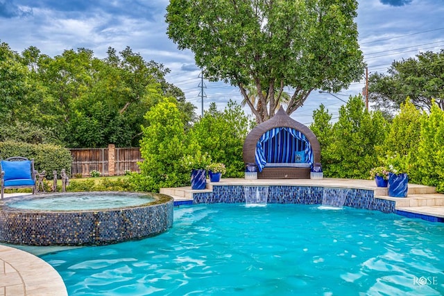 view of swimming pool featuring an in ground hot tub and pool water feature