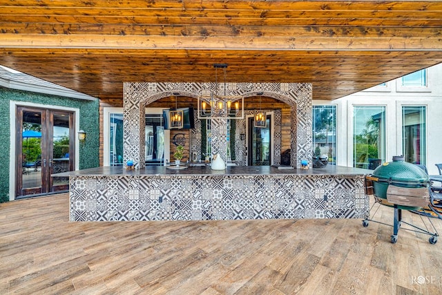 exterior space featuring area for grilling, a bar, and french doors