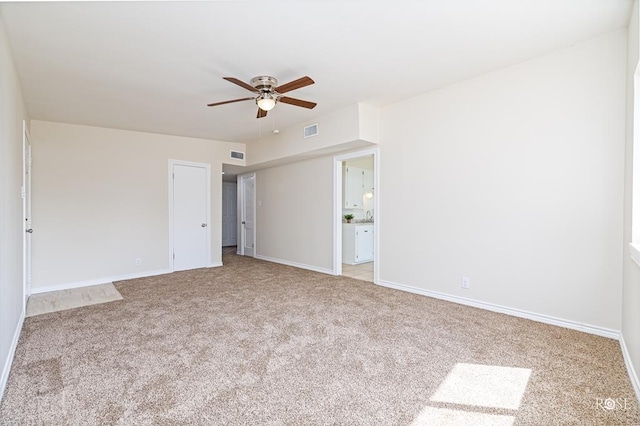 unfurnished bedroom featuring light carpet and ceiling fan