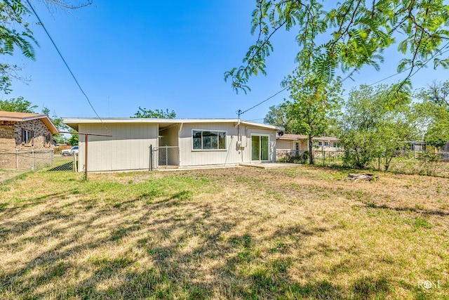 back of house with a yard