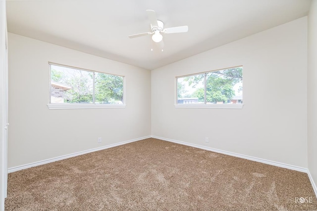 spare room with lofted ceiling, carpet floors, and ceiling fan