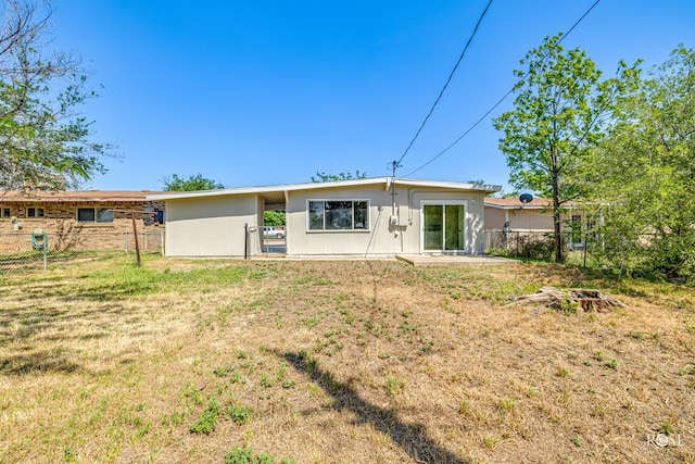 back of property featuring a lawn