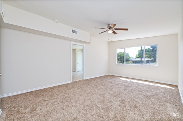 empty room with light colored carpet and ceiling fan