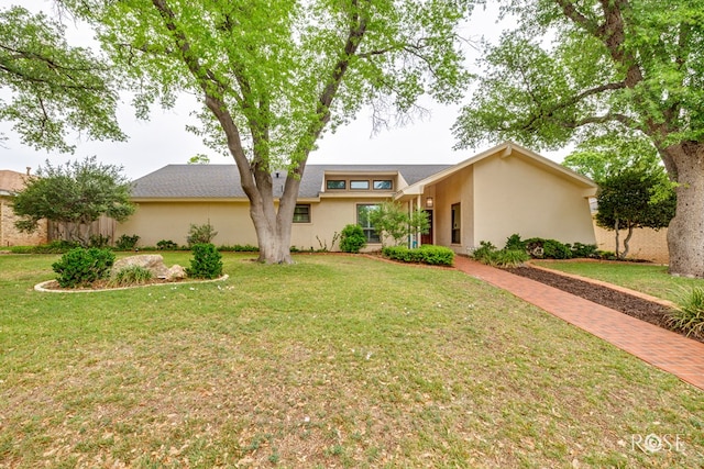 3210 Briargrove Ln, San Angelo, TX 76904 - view of front facade with stucco siding and a front lawn