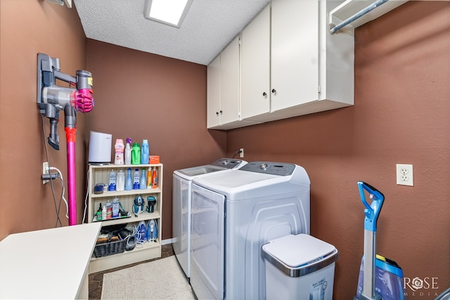 3210 Briargrove Ln, San Angelo, TX 76904 - laundry room featuring a textured ceiling, cabinet space, and washer and clothes dryer