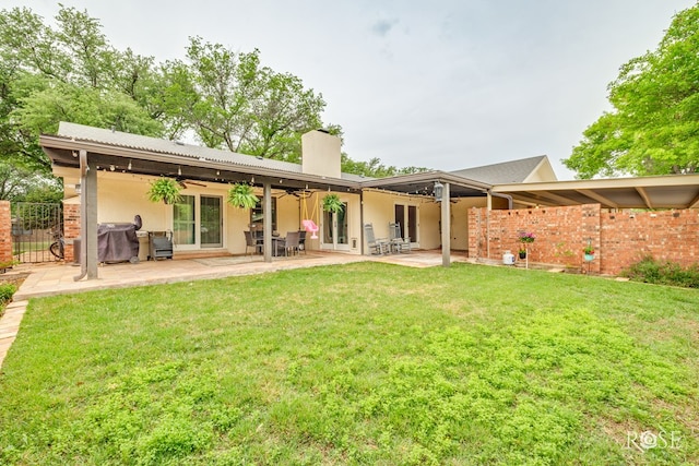 3210 Briargrove Ln, San Angelo, TX 76904 - rear view of house with ceiling fan, fence, a chimney, a patio area, and a lawn