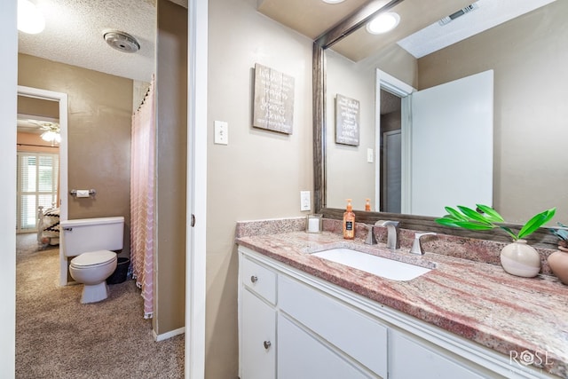 3210 Briargrove Ln, San Angelo, TX 76904 - full bathroom featuring visible vents, a ceiling fan, toilet, and vanity