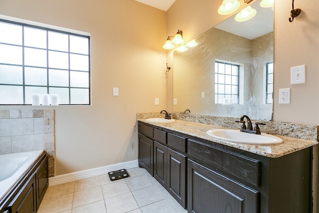 bathroom with vanity, a washtub, and tile patterned floors