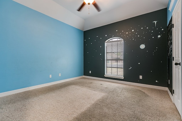 carpeted empty room featuring lofted ceiling and ceiling fan