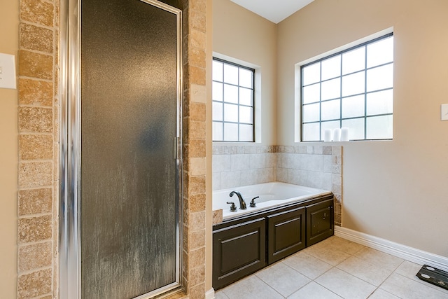 bathroom featuring tile patterned flooring and plus walk in shower