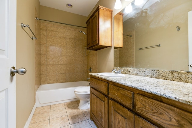 full bathroom with tile patterned floors, vanity, toilet, and tiled shower / bath combo