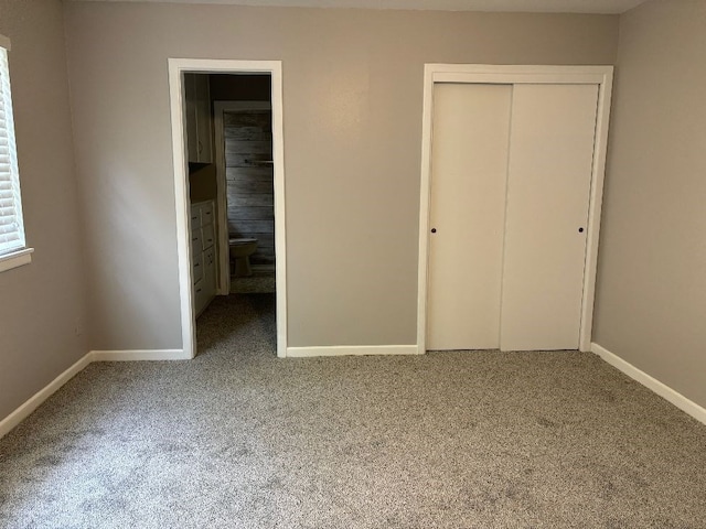 unfurnished bedroom featuring carpet floors and a closet