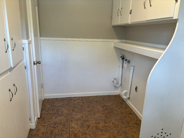 clothes washing area featuring cabinets