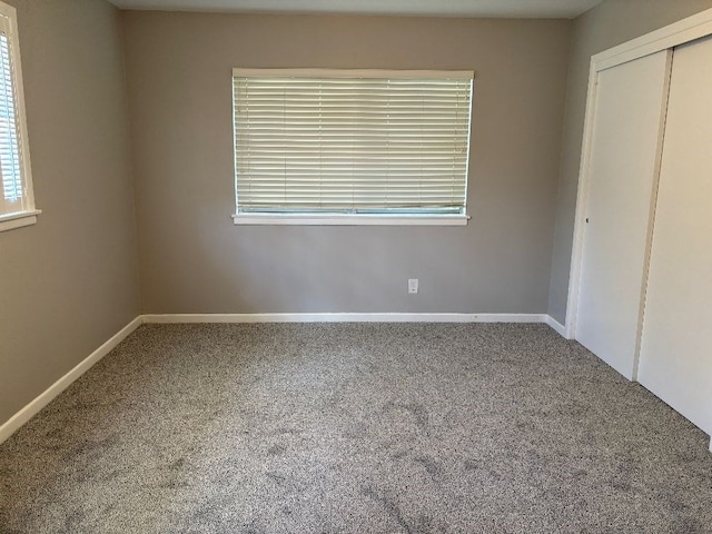 unfurnished bedroom featuring carpet flooring and a closet