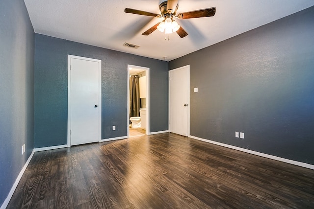 3101 Grove Dr, San Angelo, TX 76903 - unfurnished bedroom with wood finished floors, baseboards, ensuite bath, and a ceiling fan