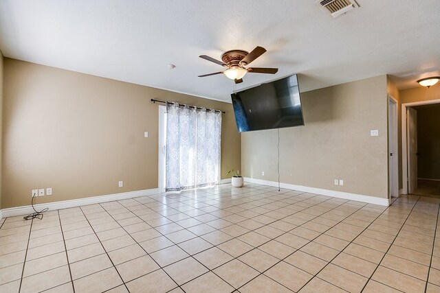 3101 Grove Dr, San Angelo, TX 76903 - unfurnished room with a ceiling fan, light tile patterned floors, and baseboards