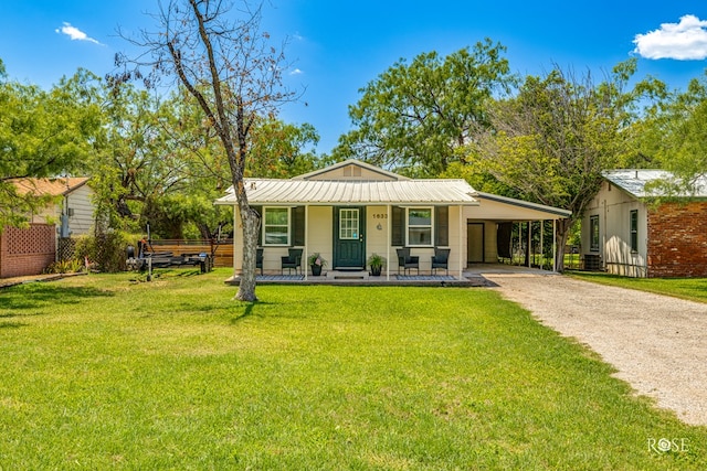 single story home with a front yard, a carport, and covered porch