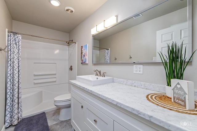 full bathroom with vanity, shower / bath combo with shower curtain, and toilet