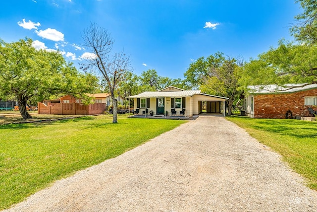 ranch-style house featuring a porch, a carport, and a front lawn