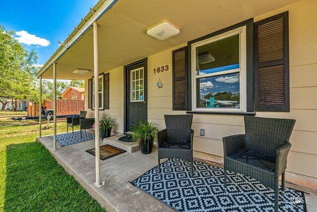 view of front of property featuring a carport, a front yard, covered porch, and central air condition unit