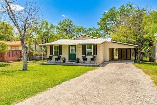 view of front facade featuring a carport, cooling unit, covered porch, and a front lawn