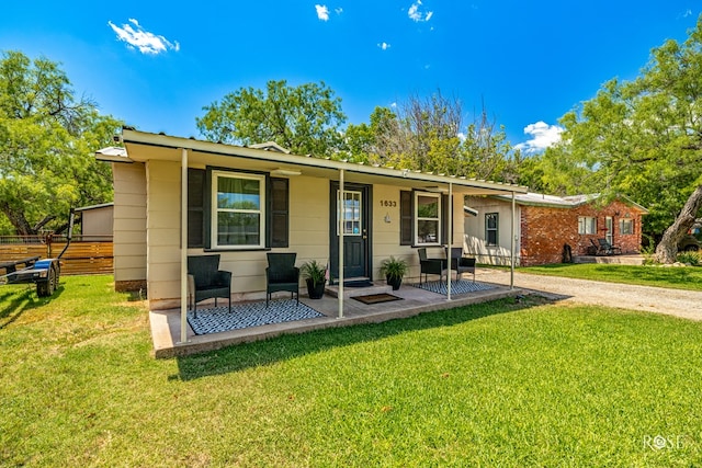 ranch-style house with covered porch and a front lawn