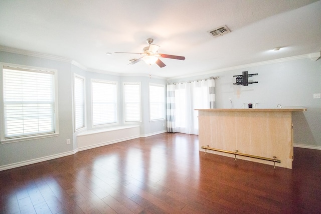 interior space with ceiling fan, ornamental molding, and dark hardwood / wood-style flooring