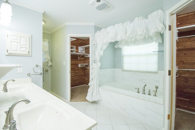 bathroom with tiled tub, crown molding, tile patterned flooring, and vanity