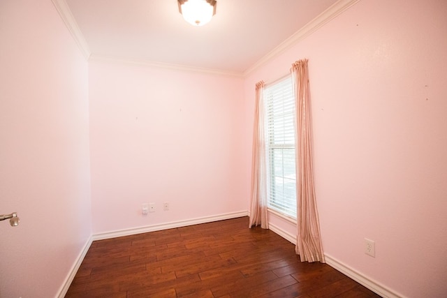 empty room featuring ornamental molding and dark wood-type flooring