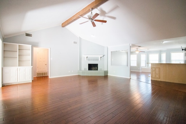 unfurnished living room with dark wood-type flooring, a fireplace, beam ceiling, and ceiling fan