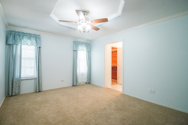 spare room with ornamental molding, light colored carpet, and ceiling fan