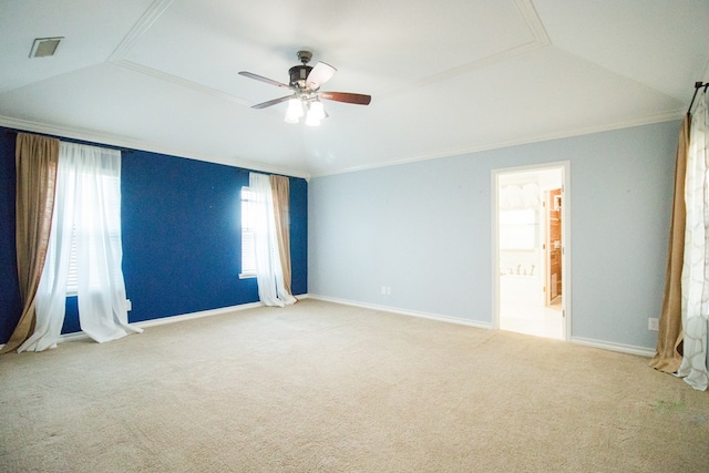 carpeted empty room featuring vaulted ceiling, ornamental molding, and ceiling fan