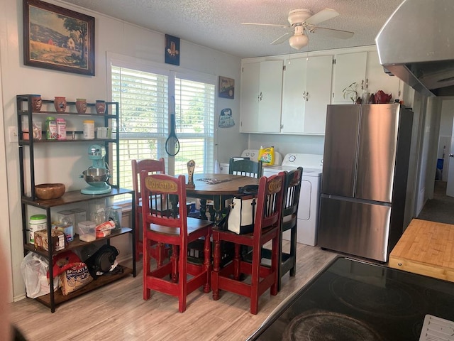 dining area with washing machine and dryer, ceiling fan, a textured ceiling, and light hardwood / wood-style floors