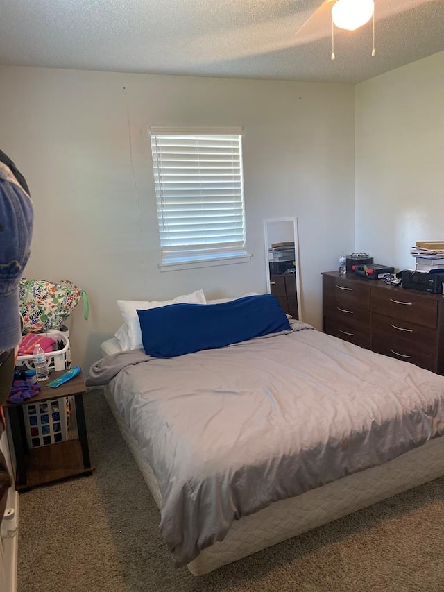 bedroom with carpet flooring, a textured ceiling, and ceiling fan