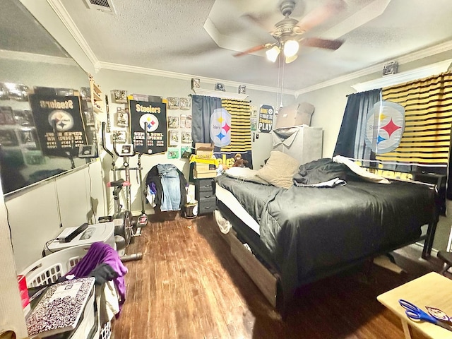 bedroom with crown molding, ceiling fan, wood-type flooring, and a textured ceiling