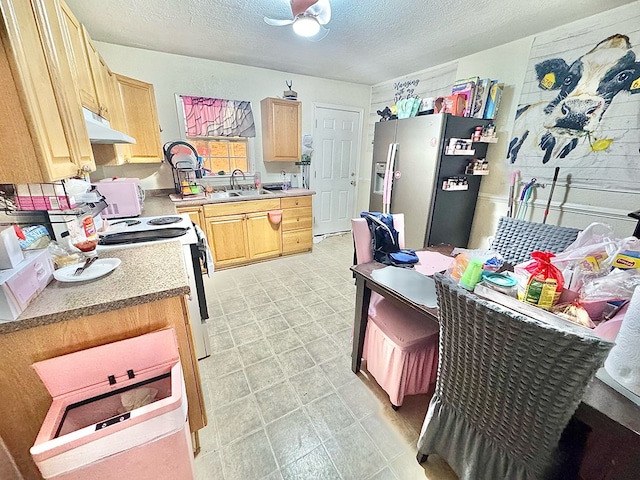 kitchen featuring light brown cabinetry, sink, white range with electric cooktop, stainless steel refrigerator with ice dispenser, and a textured ceiling