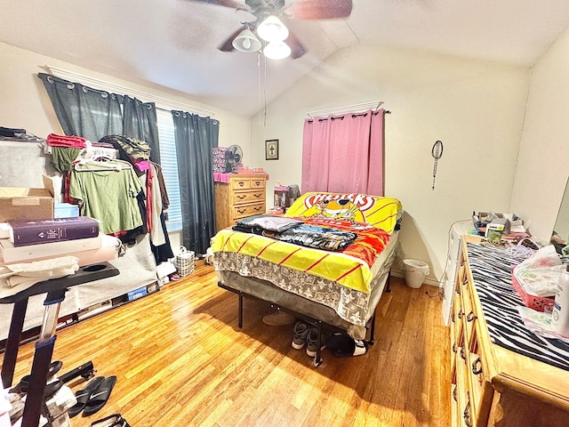 bedroom featuring ceiling fan, wood-type flooring, and vaulted ceiling