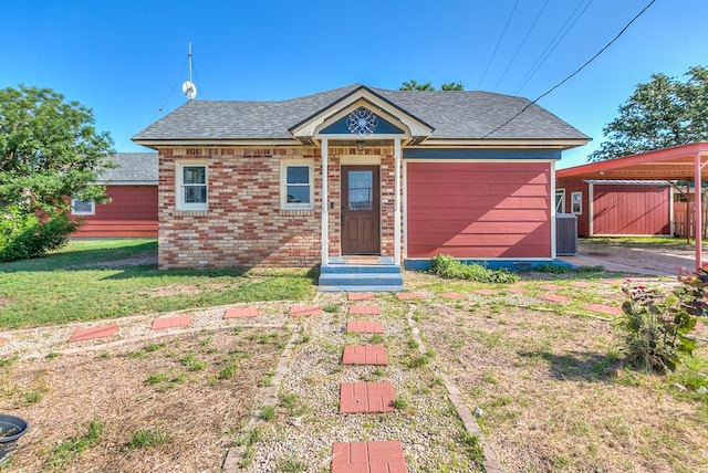 6376 Fm 380, San Angelo, TX 76905 - view of front of house with a front yard, a shingled roof, and brick siding