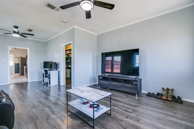 6376 Fm 380, San Angelo, TX 76905 - living area featuring ceiling fan, wood finished floors, crown molding, baseboards, and a textured ceiling
