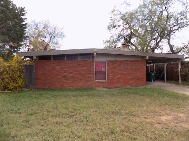 view of home's exterior featuring a carport and a yard