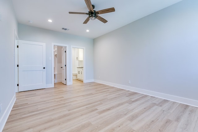 unfurnished bedroom with ensuite bath, light hardwood / wood-style flooring, and ceiling fan