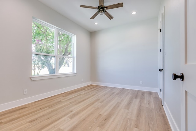 empty room featuring ceiling fan and light hardwood / wood-style floors