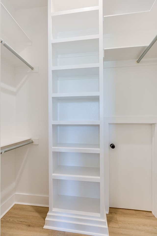 spacious closet featuring hardwood / wood-style floors