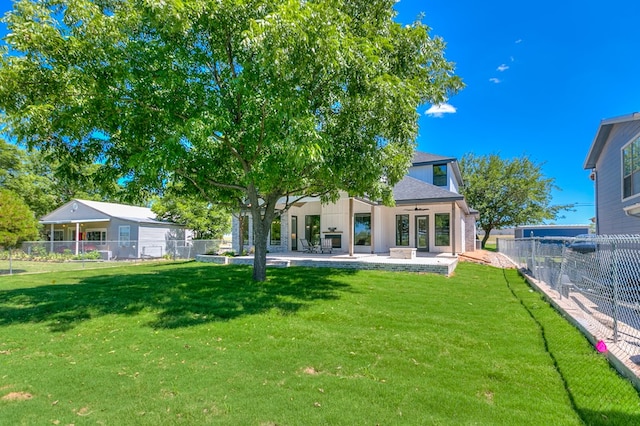 rear view of property featuring a patio, ceiling fan, and a lawn