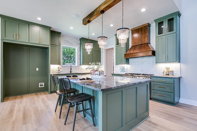 kitchen with a center island, decorative light fixtures, custom exhaust hood, dark stone counters, and beamed ceiling