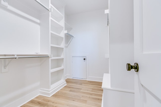 spacious closet with light hardwood / wood-style floors