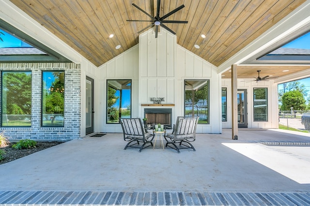 view of patio with a fireplace and ceiling fan