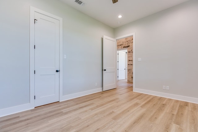 unfurnished bedroom with ceiling fan and light wood-type flooring